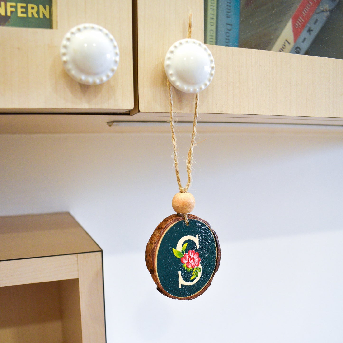 Hand painted custom initial wood charm hanging on desk