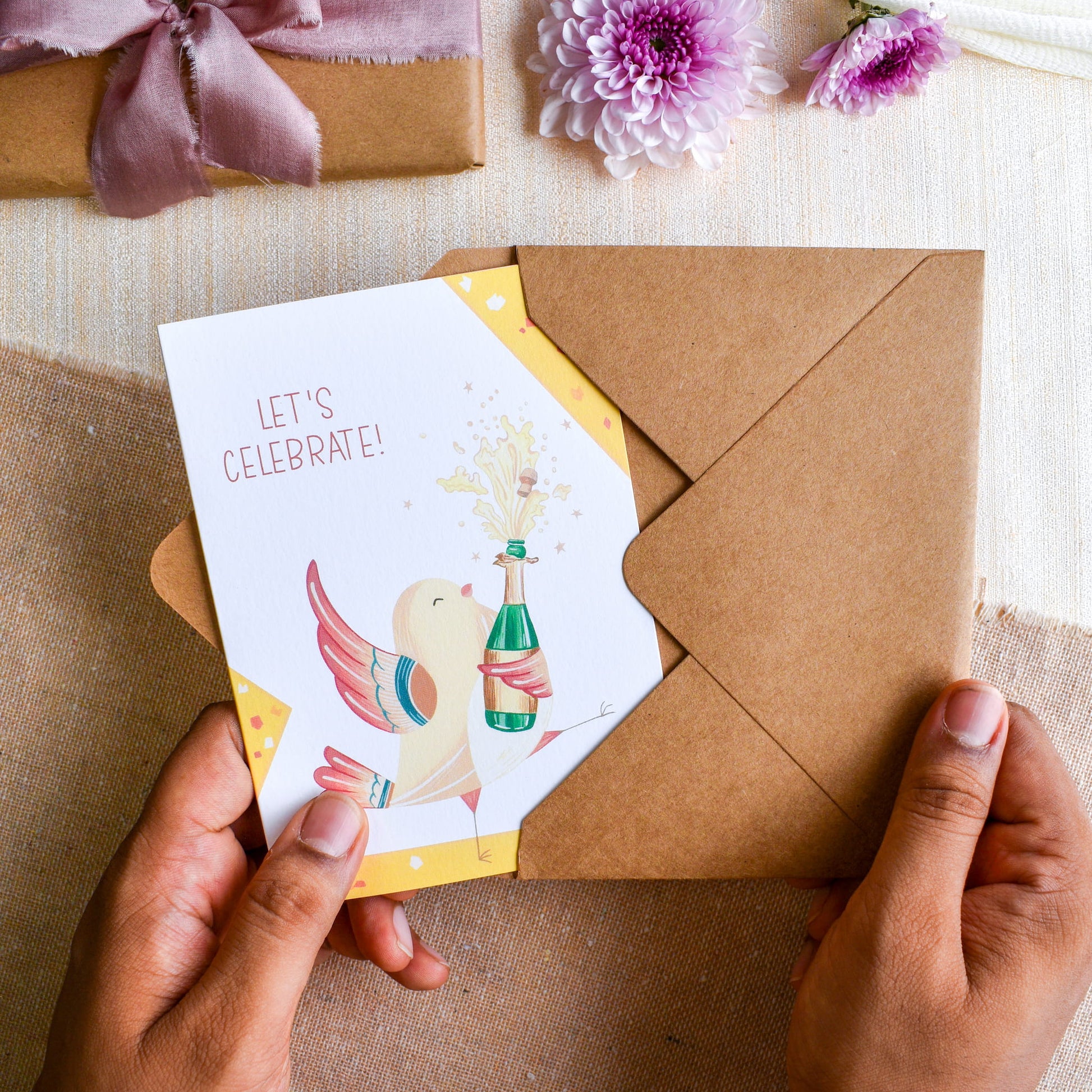 Cute dancing sparrow popping champagne greeting card in kraft paper envelope